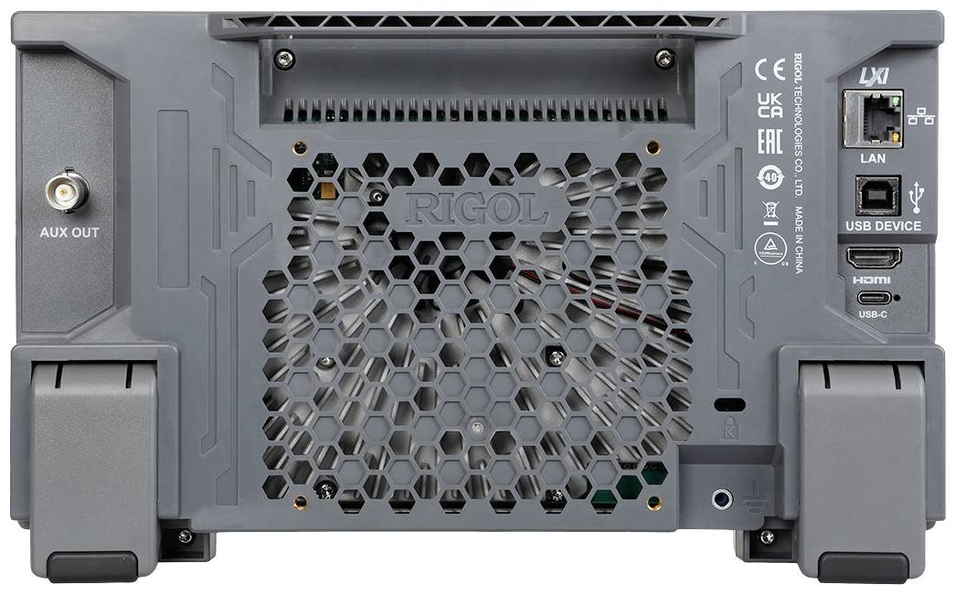 Rear view of a grey electronic device with ventilation grille, LAN port, HDMI, USB and AUX OUT. Markings indicate model information.