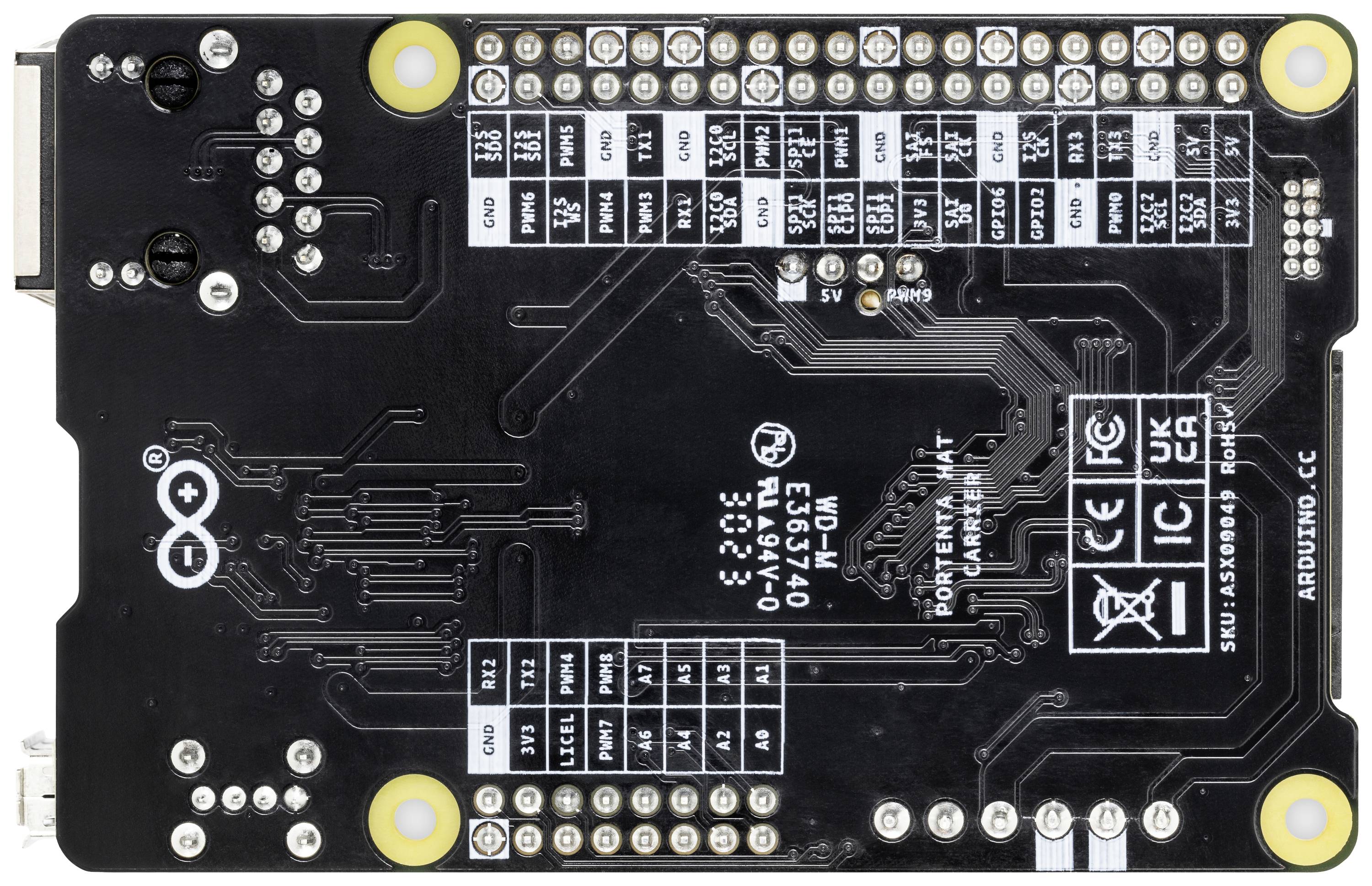 Back of an Arduino circuit board with connectors and circuits. Various technical prints and logos are visible.