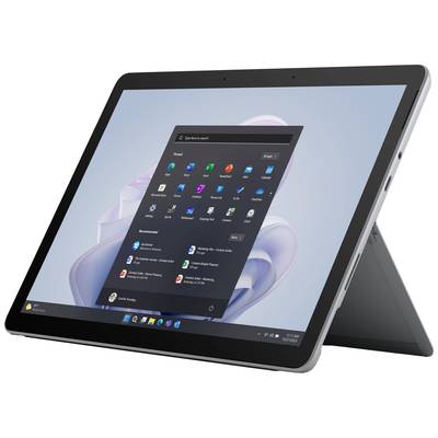 A tablet with its stand unfolded displays the Windows 11 start screen with multiple application icons and the search bar.