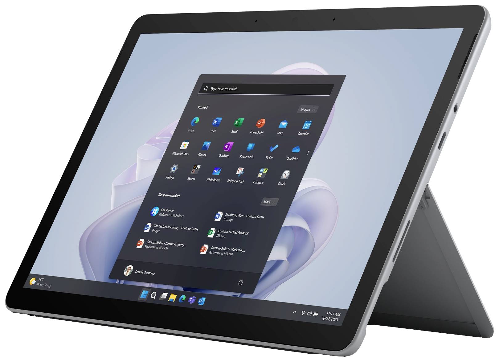 A silver tablet with its stand unfolded displays a Windows screen. Apps and the Start menu are visible.