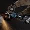 A person is grinding metal with an angle grinder, with sparks flying. They are wearing protective clothing, including gloves.