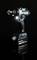 A blue cordless drill stands upright on a black background, the 'Makita' brand visible on the battery, with an LED light illuminated.