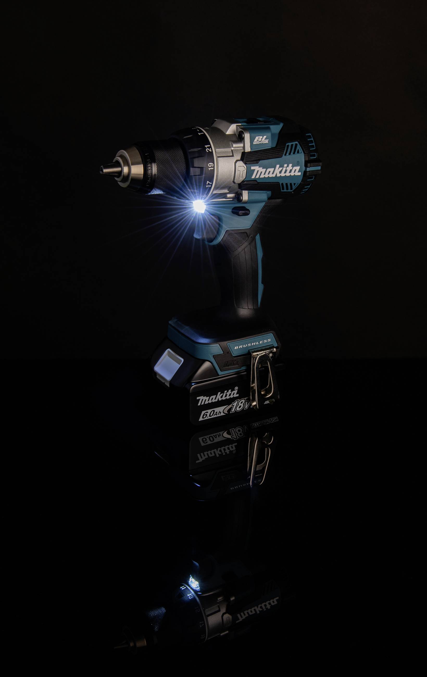 Cordless drill with LED light illuminates on dark surface, brand visible, suitable for craftwork.