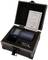 A digital measuring instrument in an open black case with a guarantee certificate. The device features a display and control buttons.