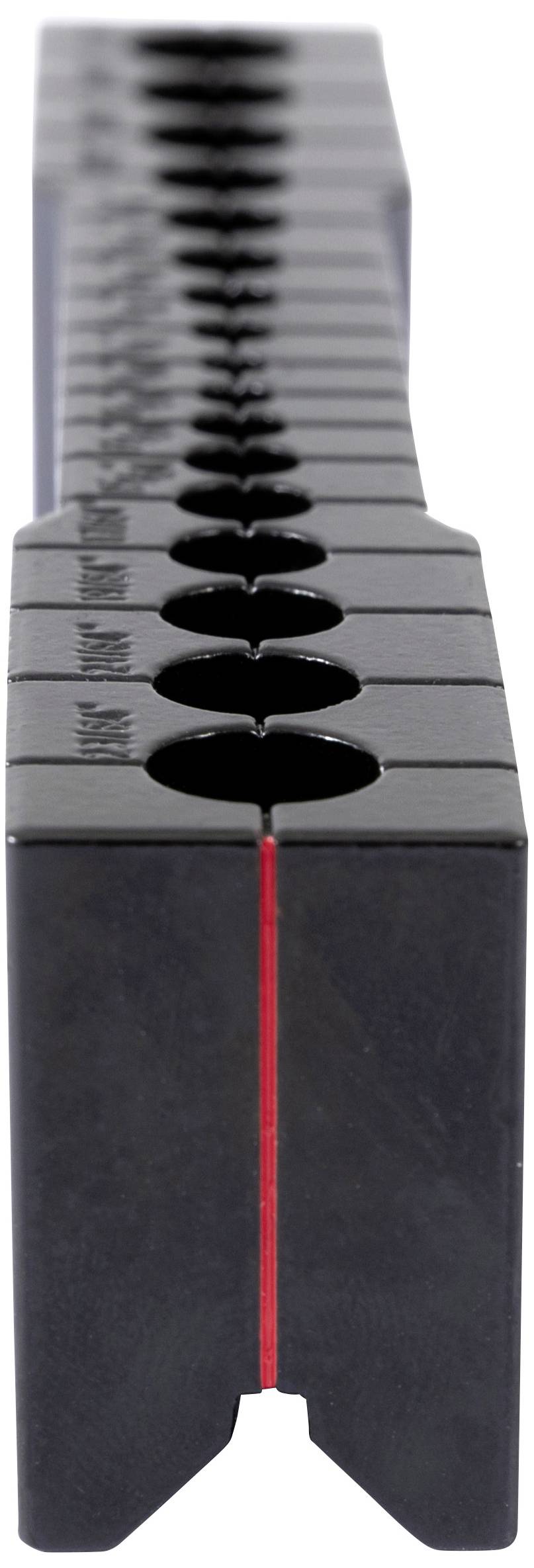 Black, rectangular block with several round indentations in a row. Primarily captured from a vertical perspective.