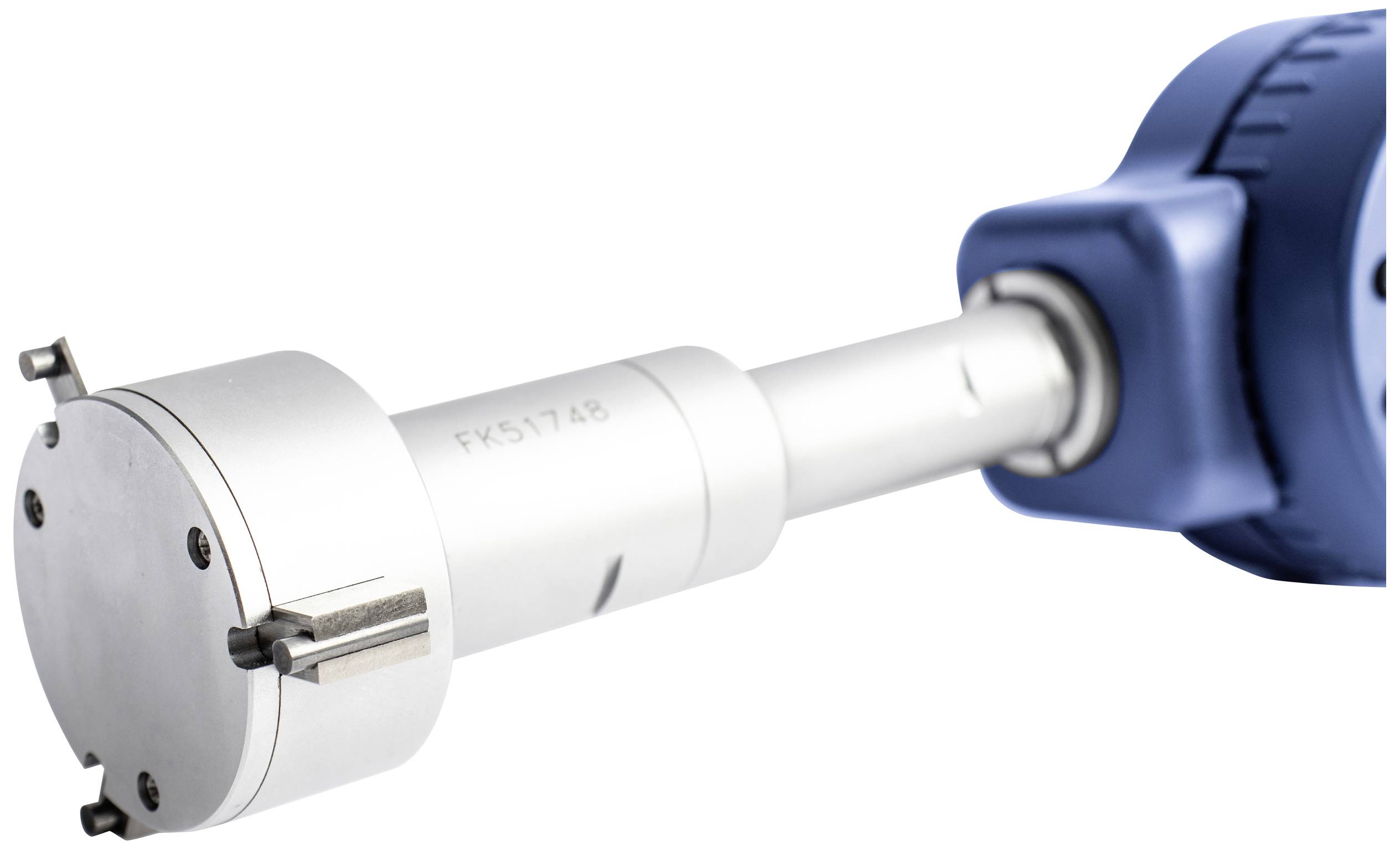 A drill with a blue grip cover and a silver drill head, positioned towards a metal surface.