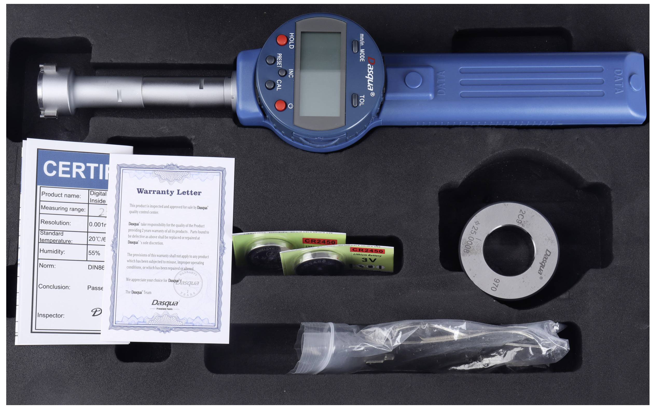 A digital measuring device with accessories in a black case, including user manual and warranty card.