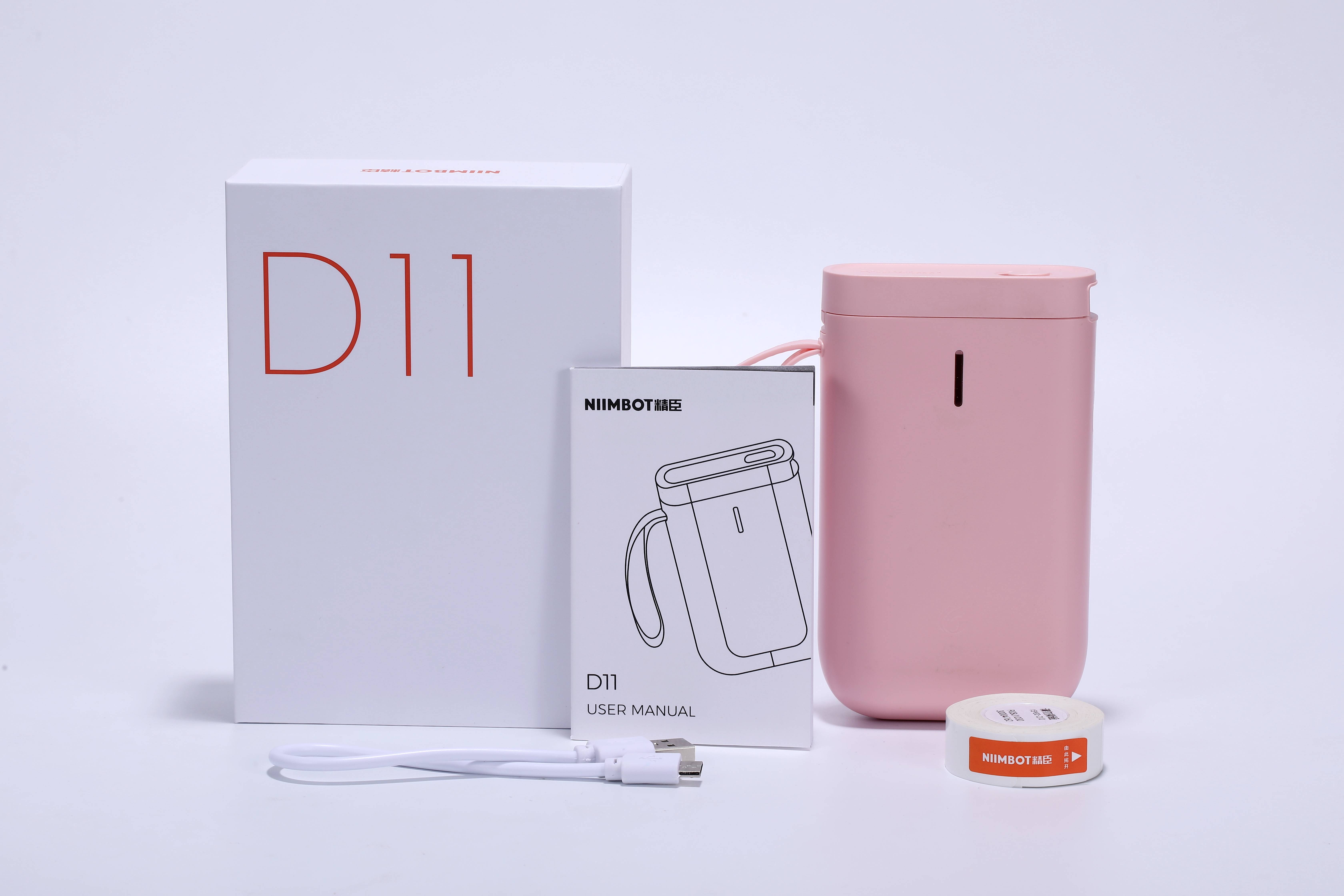'Label Printer D11 in Pink with Operating Instructions, USB Cable, Box and Label Roll. Small and Portable.'