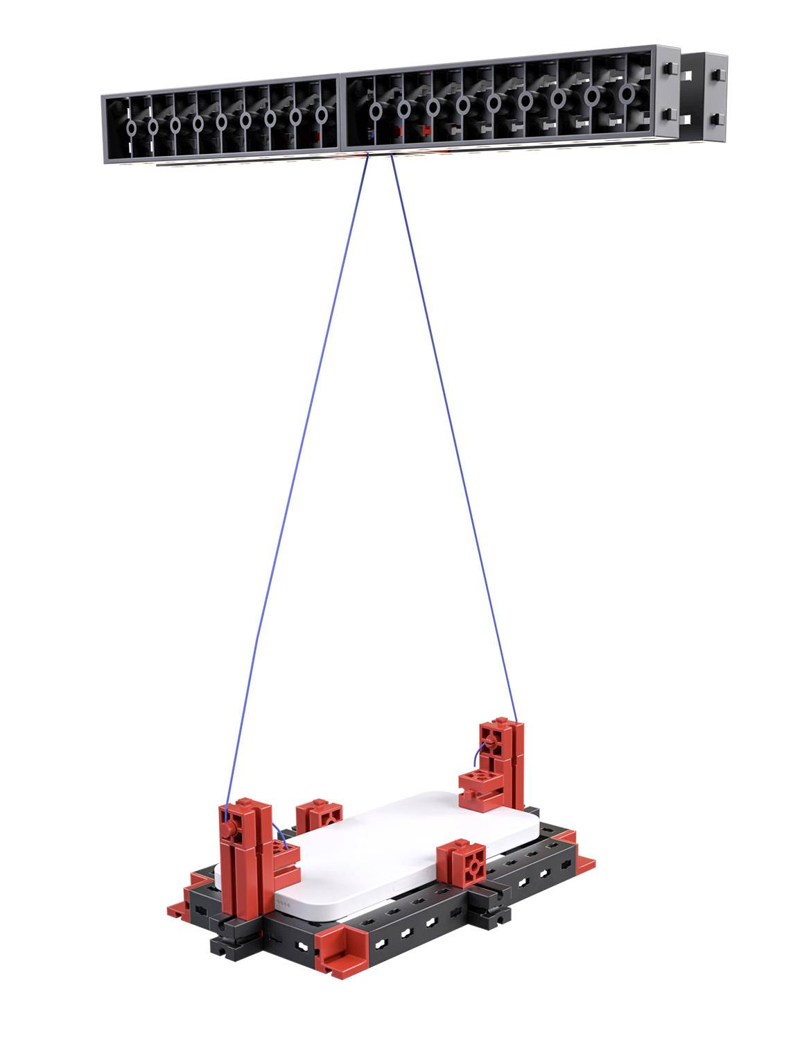 A rectangular component in red and black hangs from a black support structure by two blue cords.