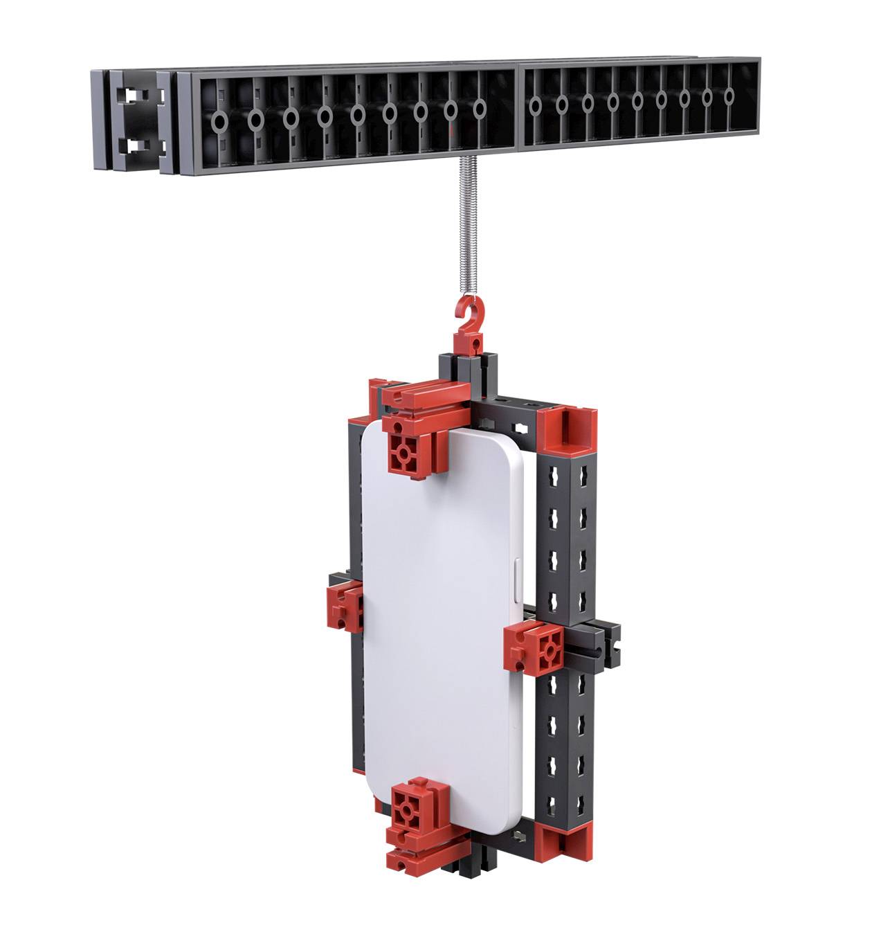 A rectangular white device is secured by a mechanical holder with red and black components. At the top, there is a clamp with multiple connections.