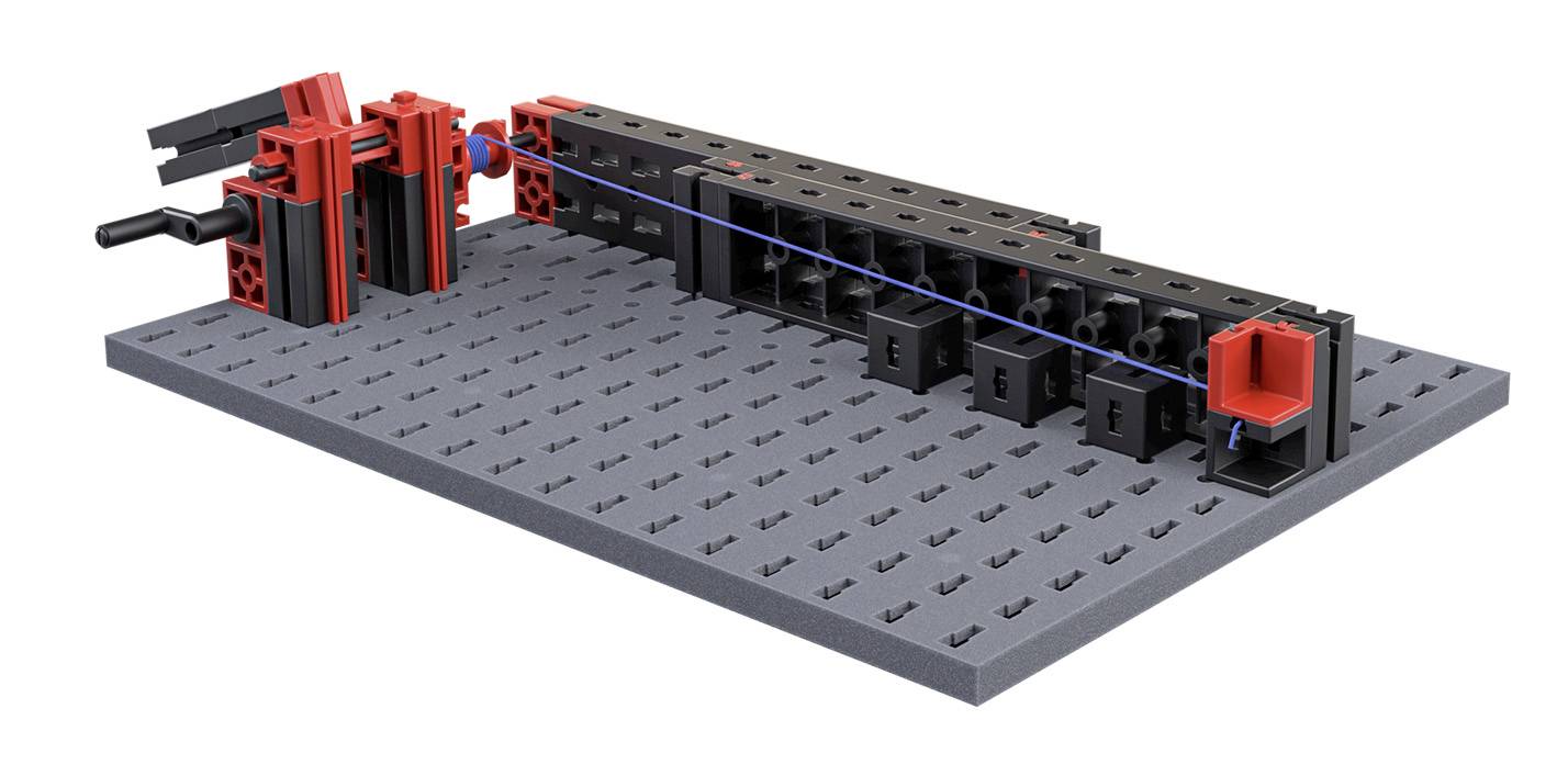 A black building base with red and black building blocks on it, connected by blue rods.