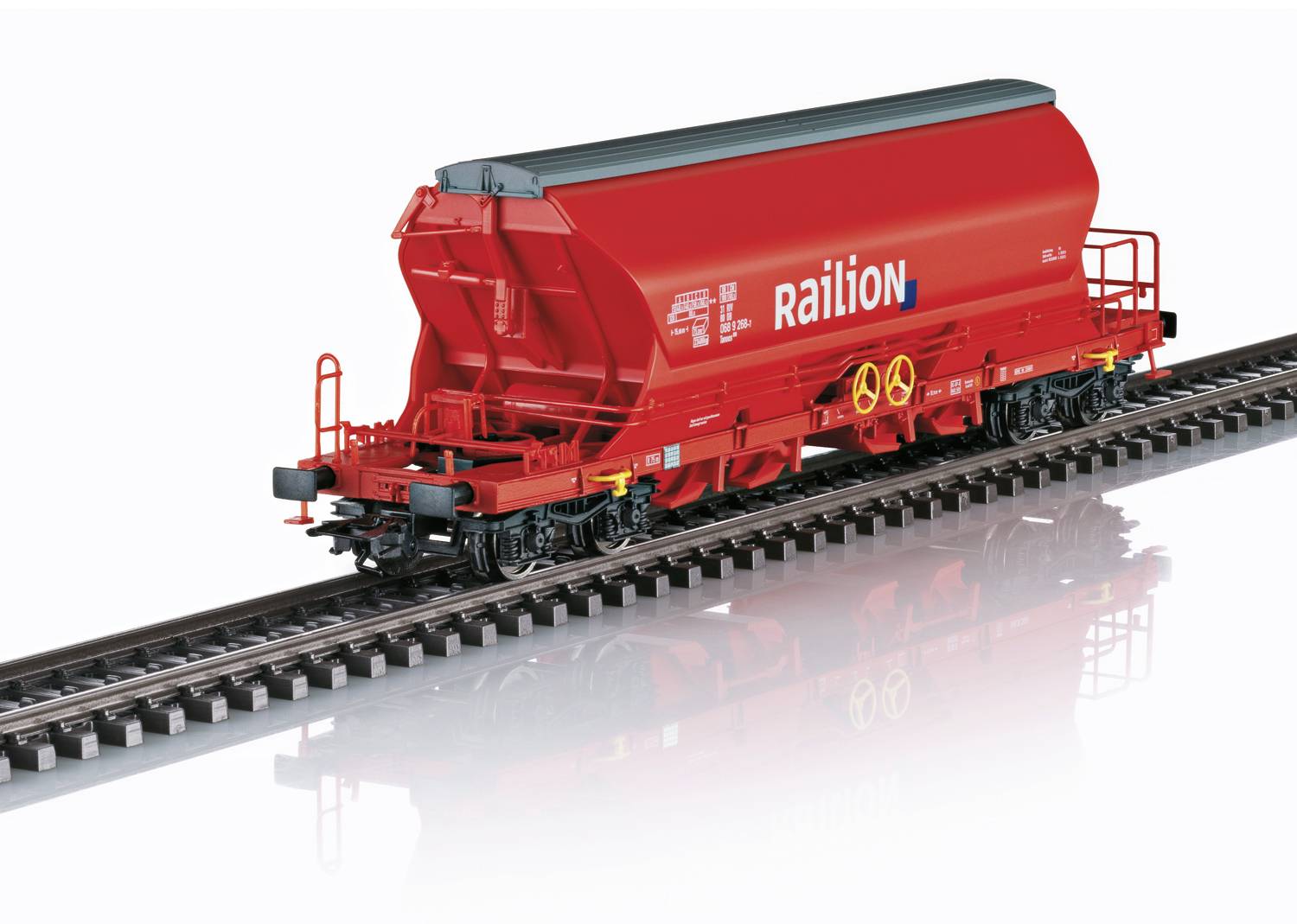 A red goods wagon stands on railway tracks. The wagon bears the inscription 'Railion'.