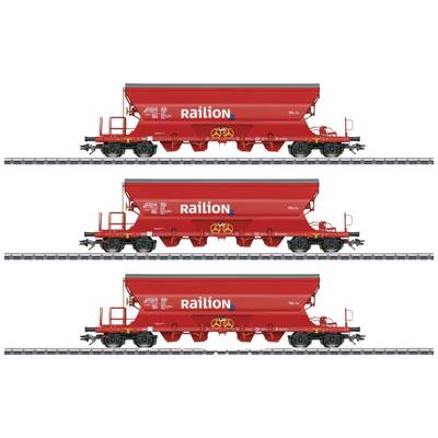Three red freight wagons of the Railion brand stand on parallel tracks, each loaded with identical containers.