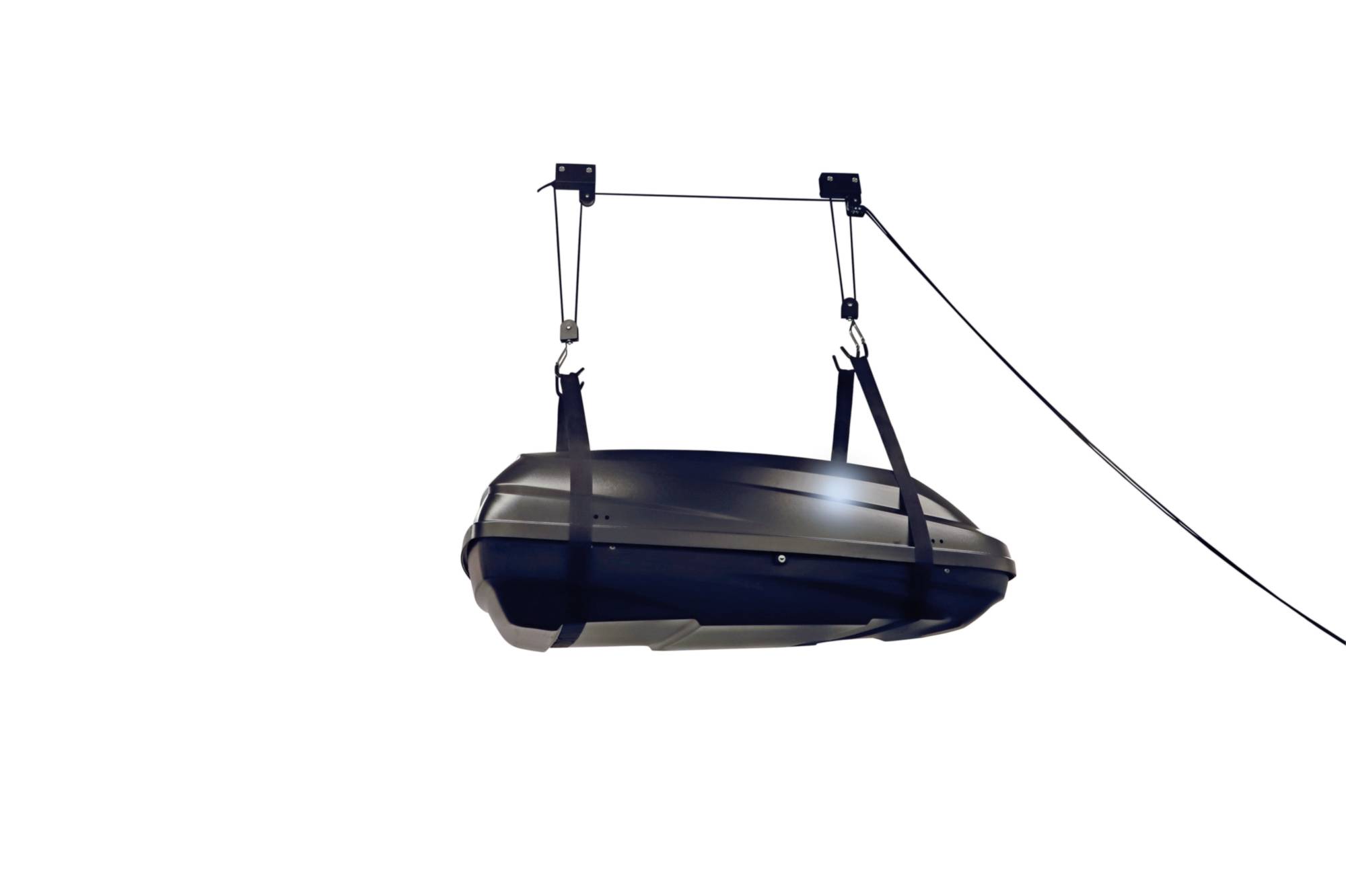 Storage box is suspended from the ceiling of a garage area using a pulley system to save space.