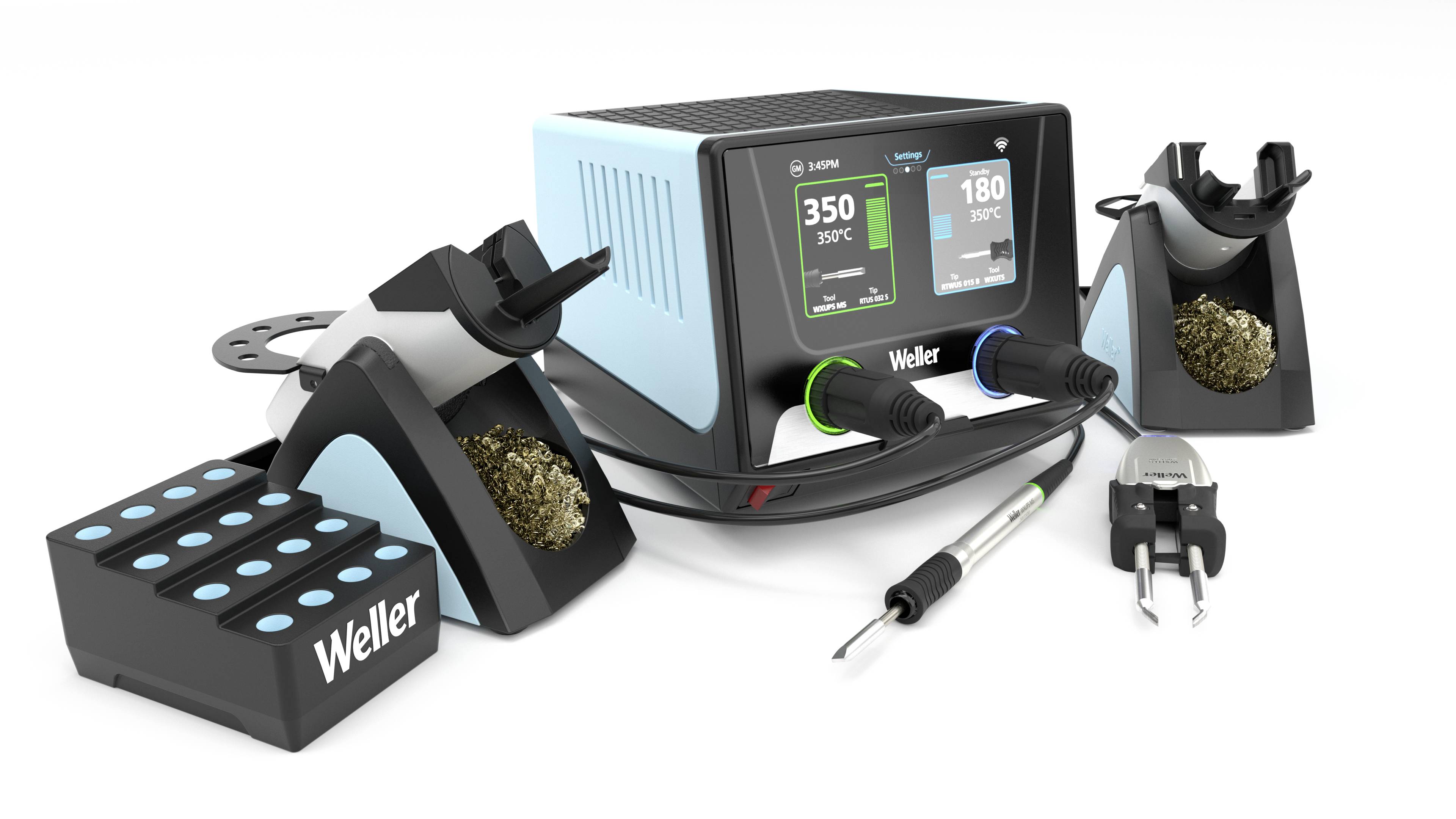 Soldering station with digital display showing '350°C', two soldering iron holders, soldering iron and cleaning accessories placed. Weller brand visible.