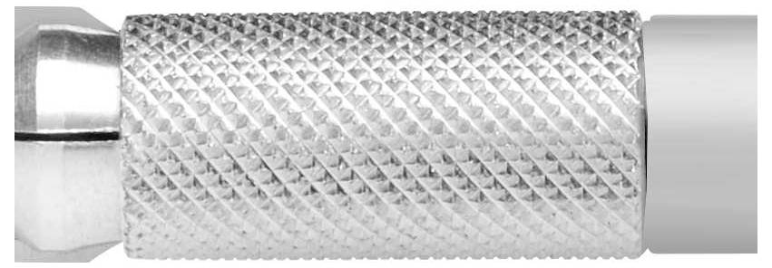 Close-up of a silver, structured metal handle with a ribbed surface, similar to a grip or tool attachment.