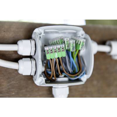 An open junction box with several connected cables of different colours, representing electrical connections.