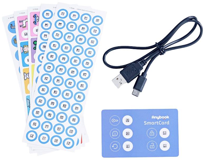 In the image, several sheets of stickers with symbols, a USB cable, and a blue 'Anybook SmartCard' with various icons are visible.