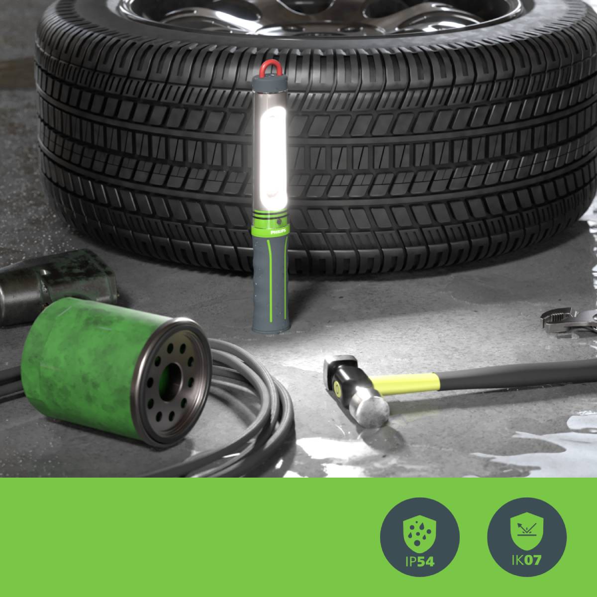 'Tyre repair scene with a glowing work lamp, complemented by tools and technical information about the lamp: IP54, IK07.'