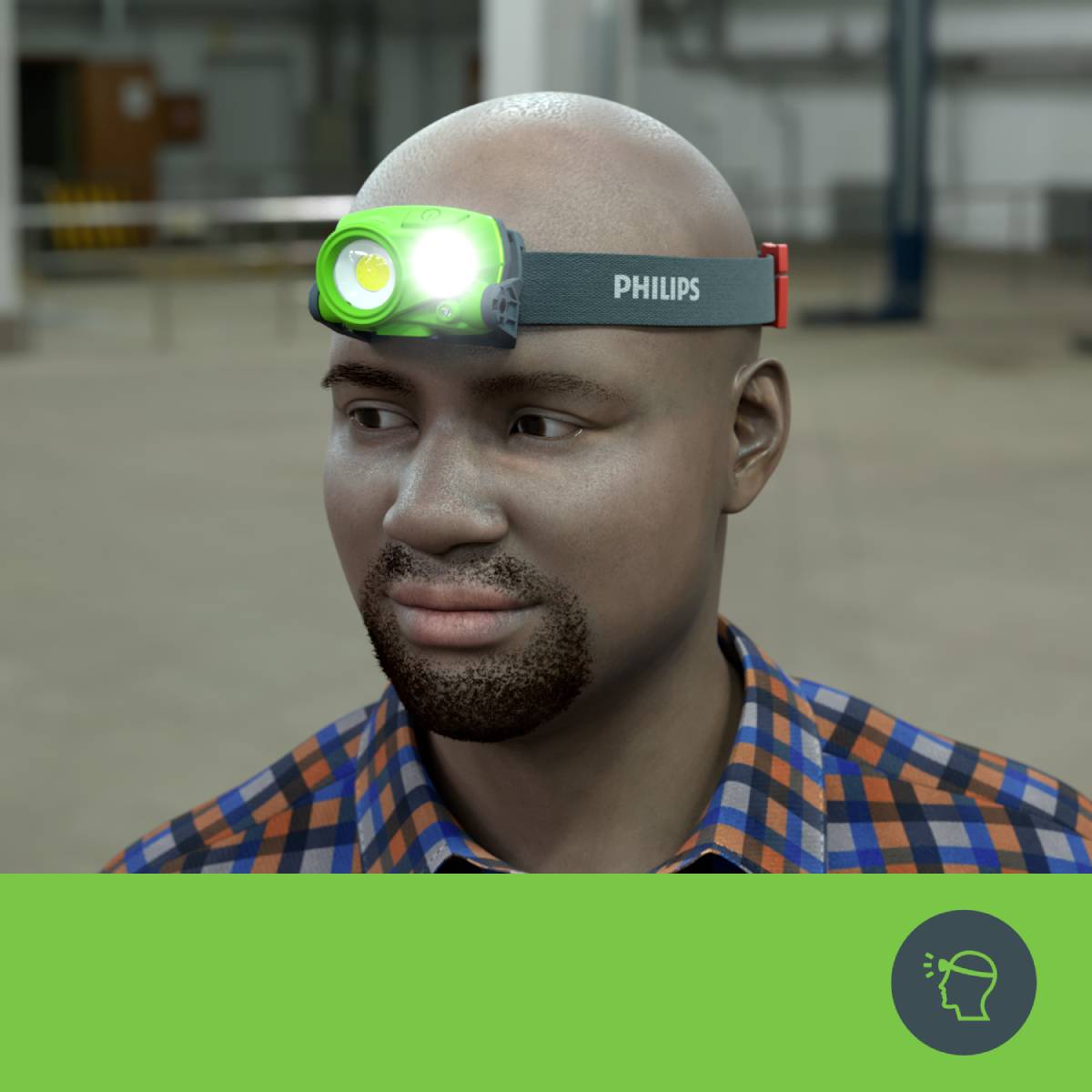 A smiling man is wearing a bright head torch in a factory environment.