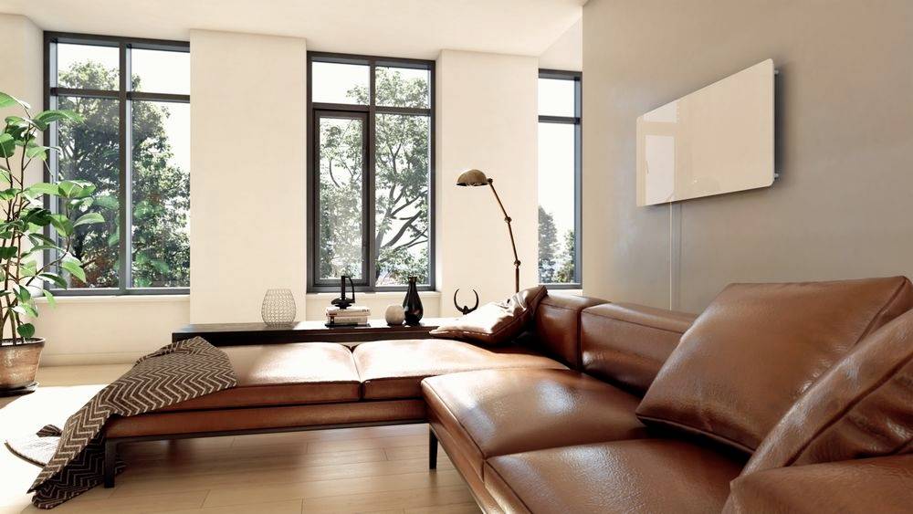 Modern living room with large windows, brown leather sofa, floor lamp and plants. Bright, welcoming atmosphere.