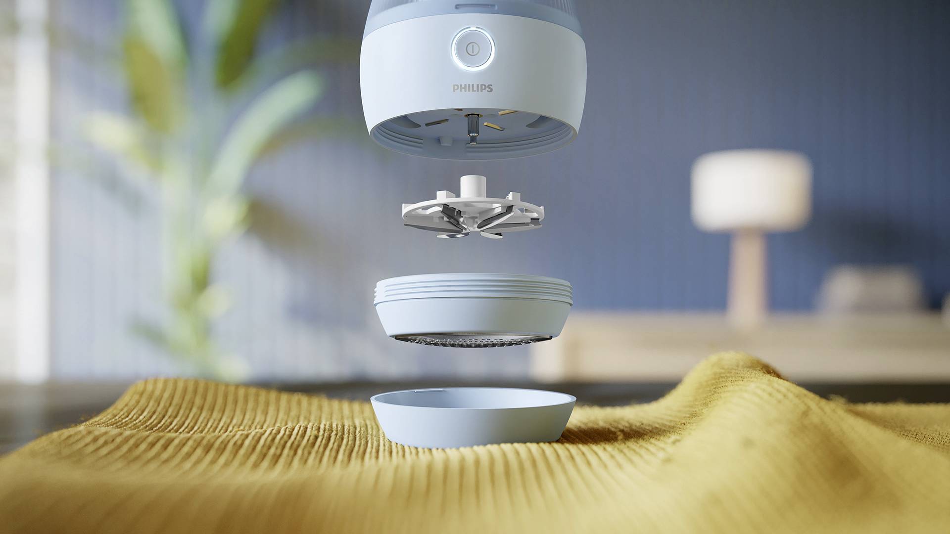 A blue air purifier is shown above a yellow blanket. The individual components are disassembled and floating in the air.