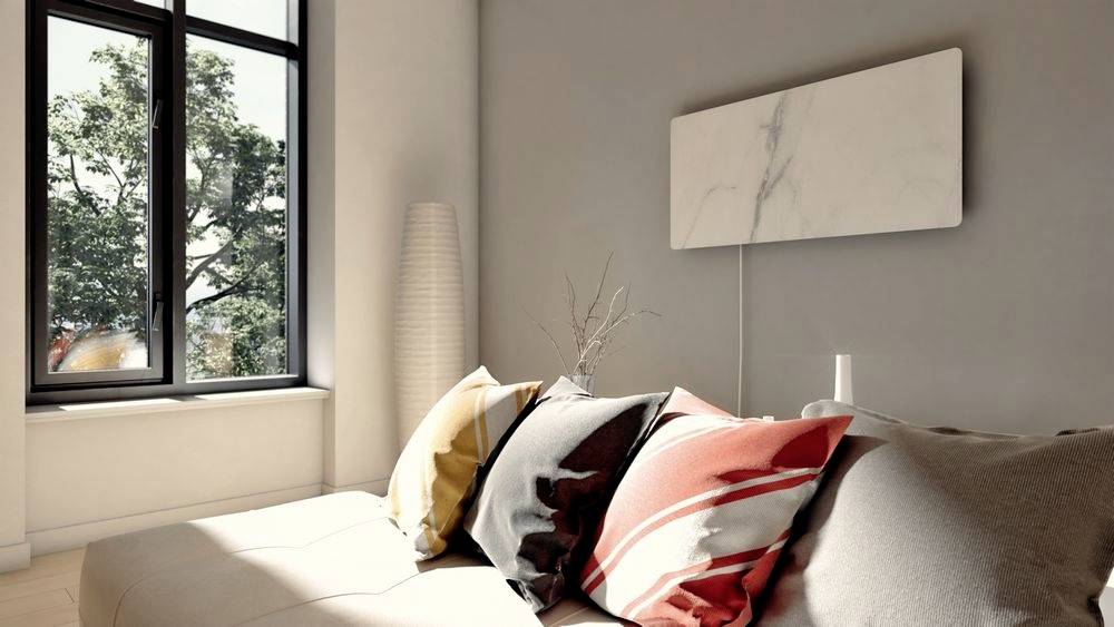 Bright bedroom with a large window, bed adorned with colourful cushions and modern decor.