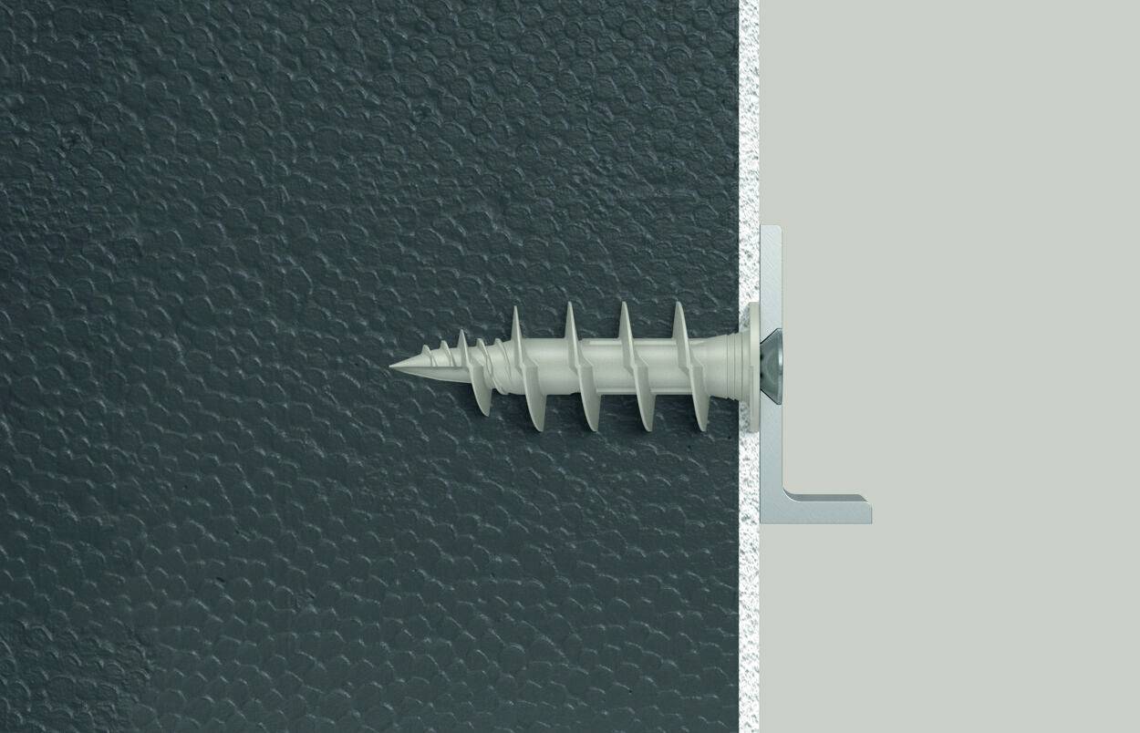 A screw is being screwed through a dark, textured-looking plate into a light, smooth surface, side view.