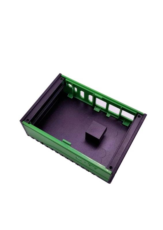 A green, empty plastic crate with a black base, interior square-shaped, standing upright. No other contents or decorations visible from this perspective.