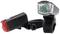 'Black bicycle lights, front light with transparent lens and red rear light mounted on brackets.'