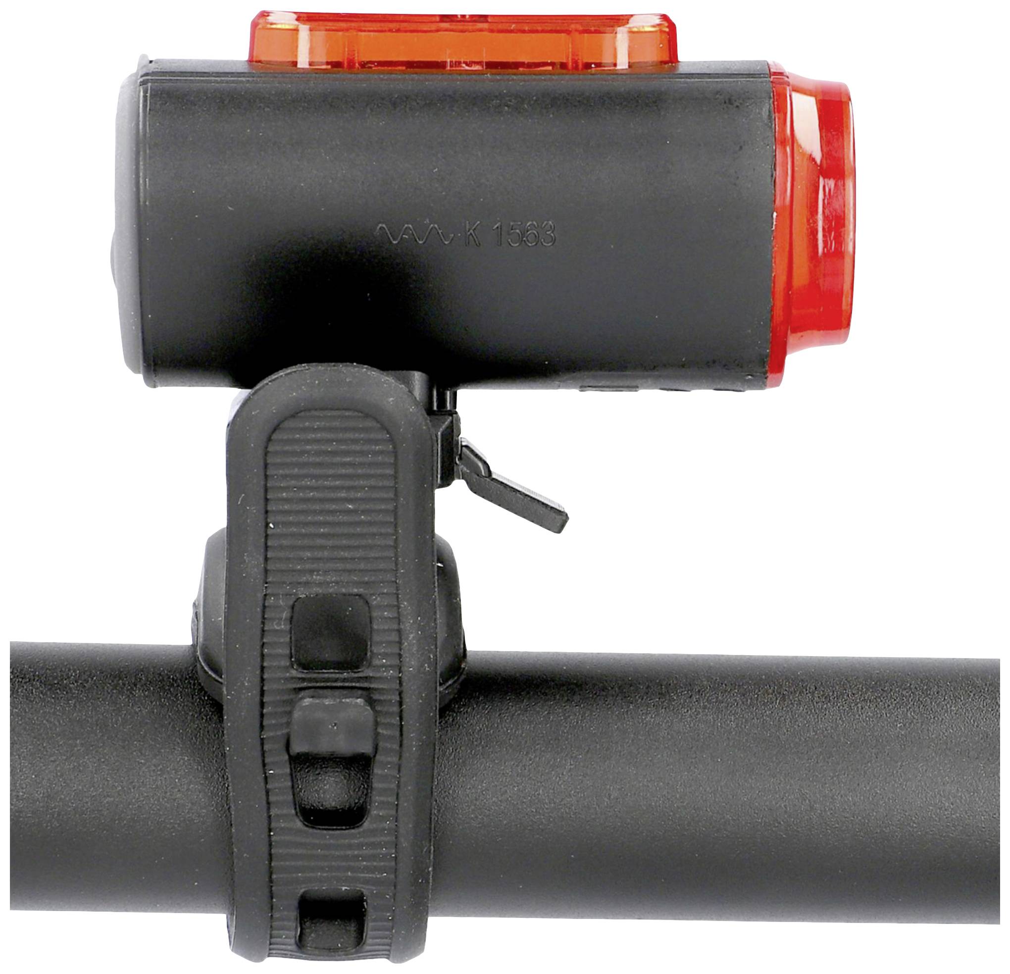 Bicycle rear light mounted on the handlebars, black with red light.