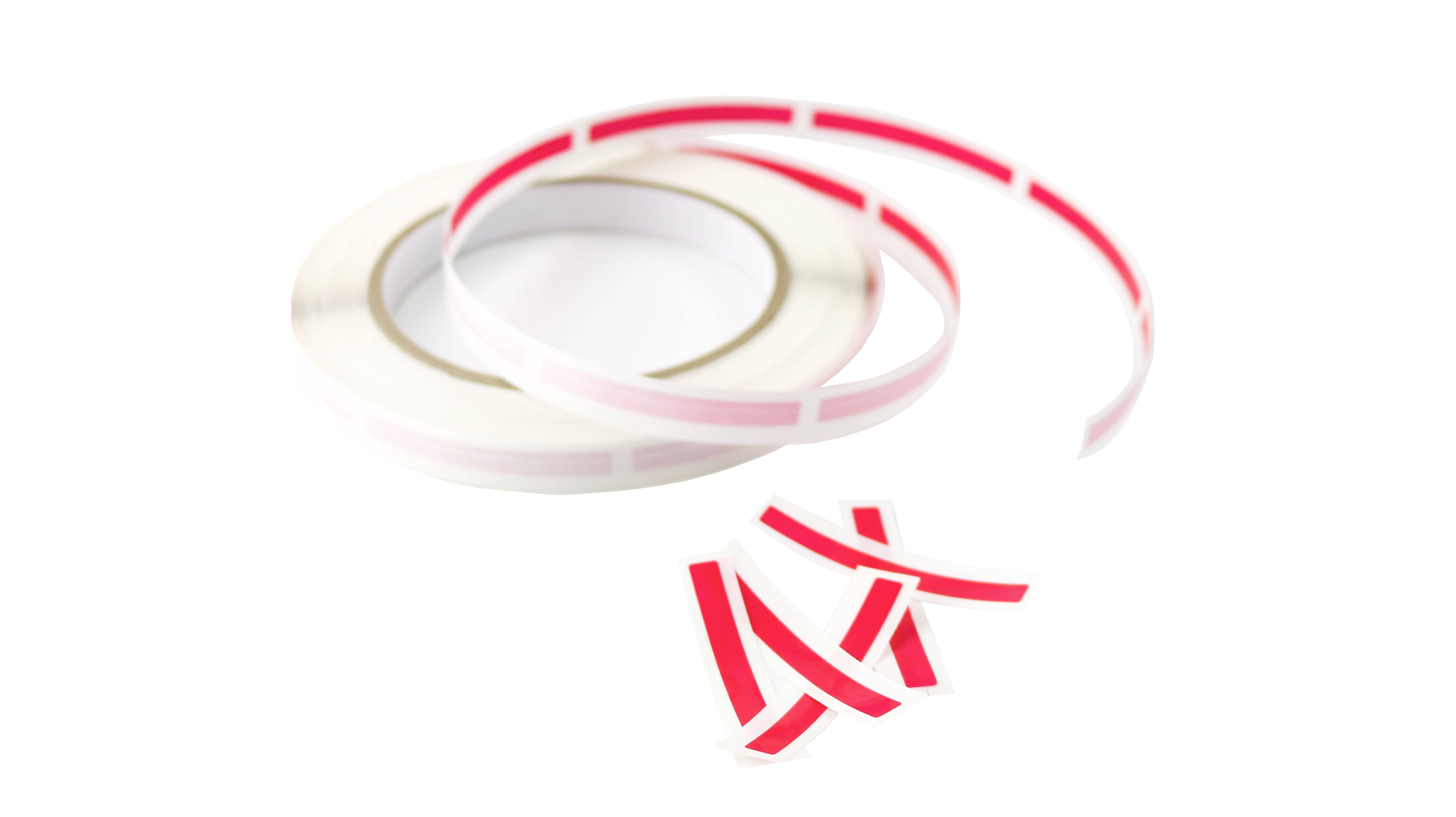 Roll of red and white striped adhesive tape, with several strips cut off. The tape could be used for markings or decorations.