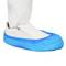 A white shoe with a blue, waterproof protective shoe cover. Suitable for sterile environments or medical areas.