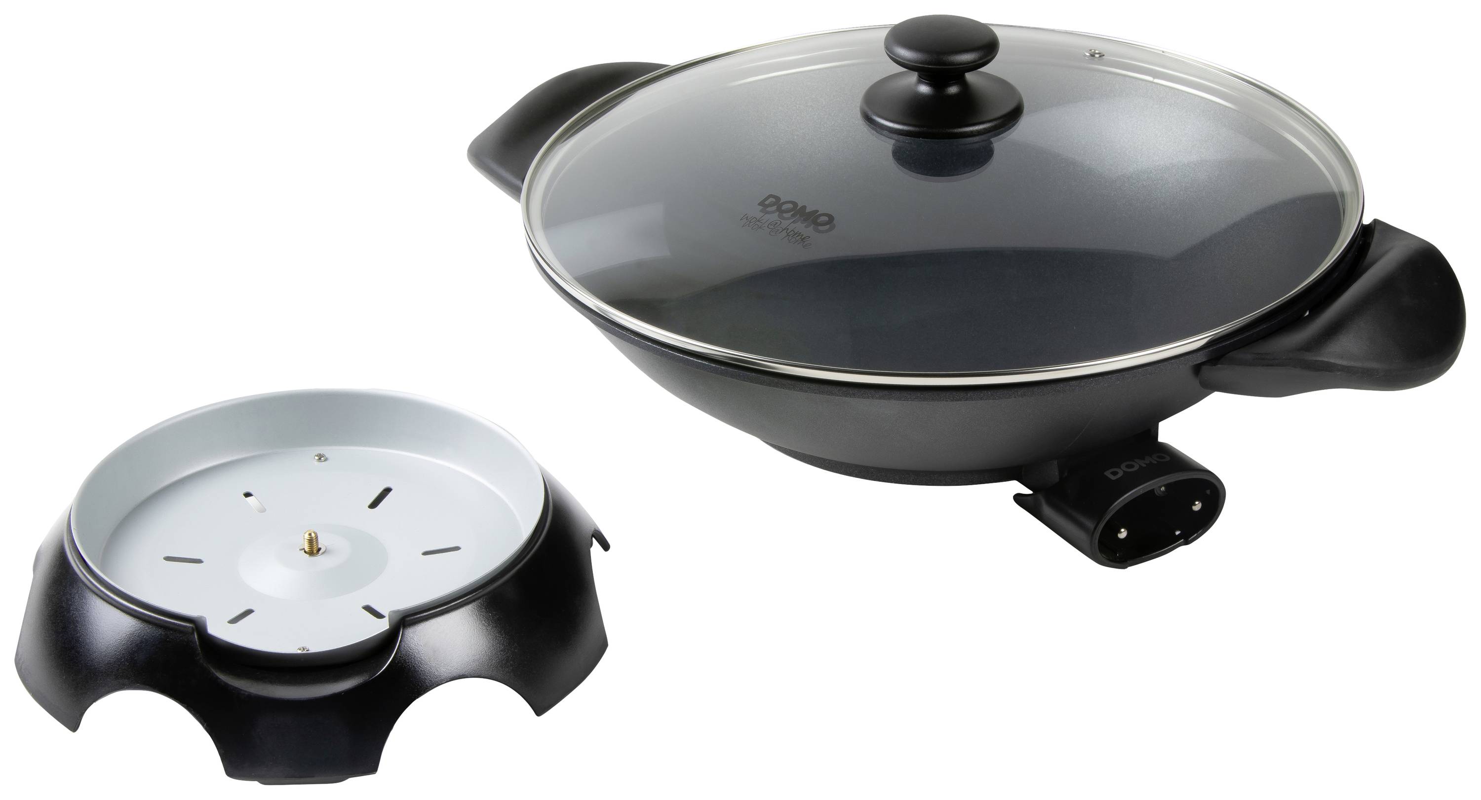 An electric frying pan with a glass lid and black handle. To the left is the corresponding base station that heats the pan.