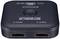 Black HDMI splitter with two HDMI outputs, a DC power input and a central button. Brand name 'SPEAKA' visible.