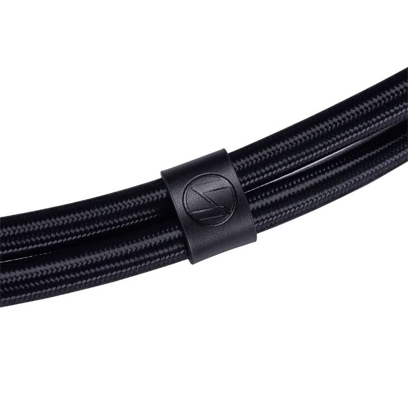 Black braided cables, bundled with a leather sleeve, bear an embossed mark. Suitable for high-quality audio connections.