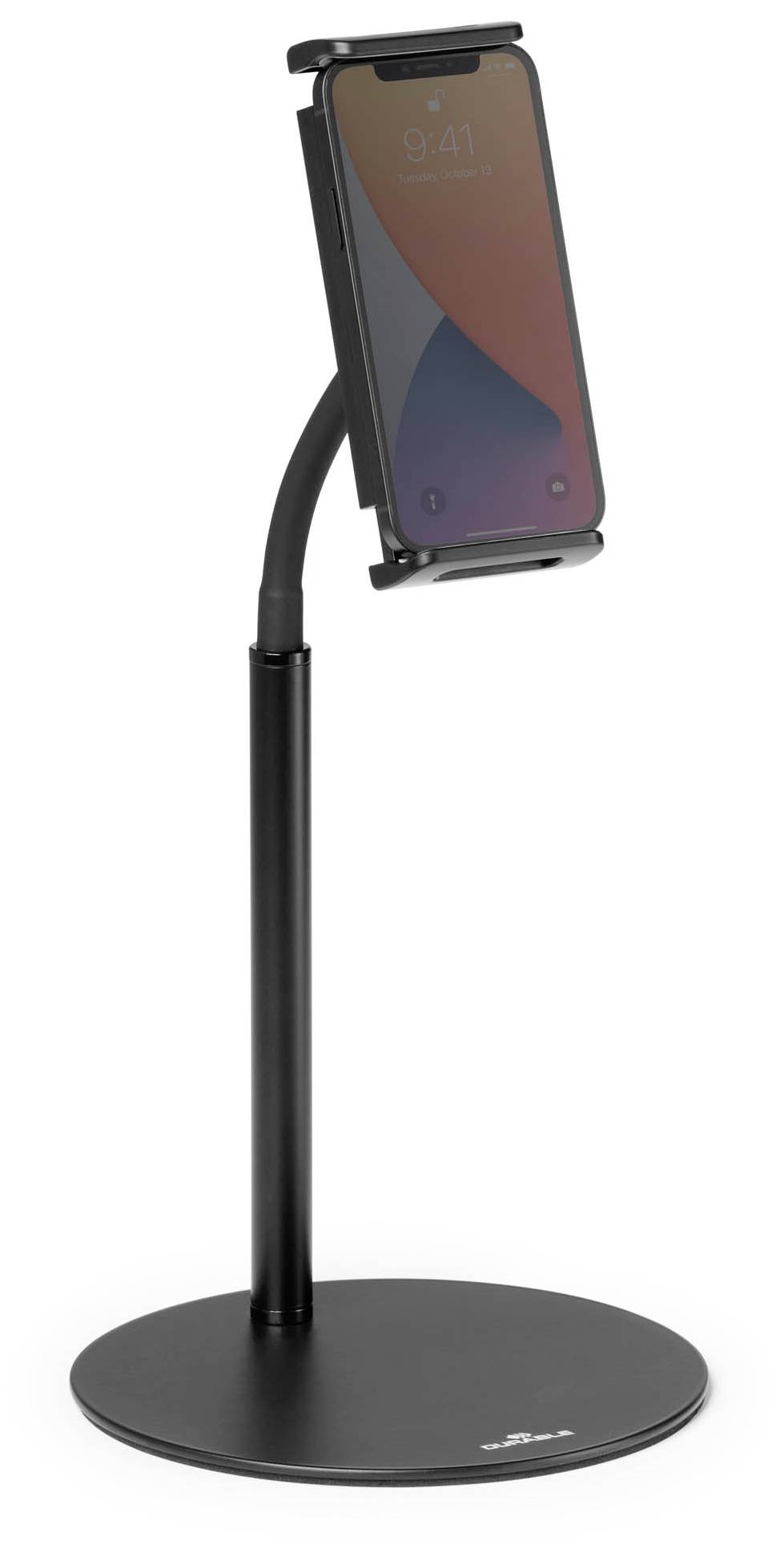 A black mobile phone holder with an adjustable arm holds a smartphone in an upright position. The holder stands on a round base.