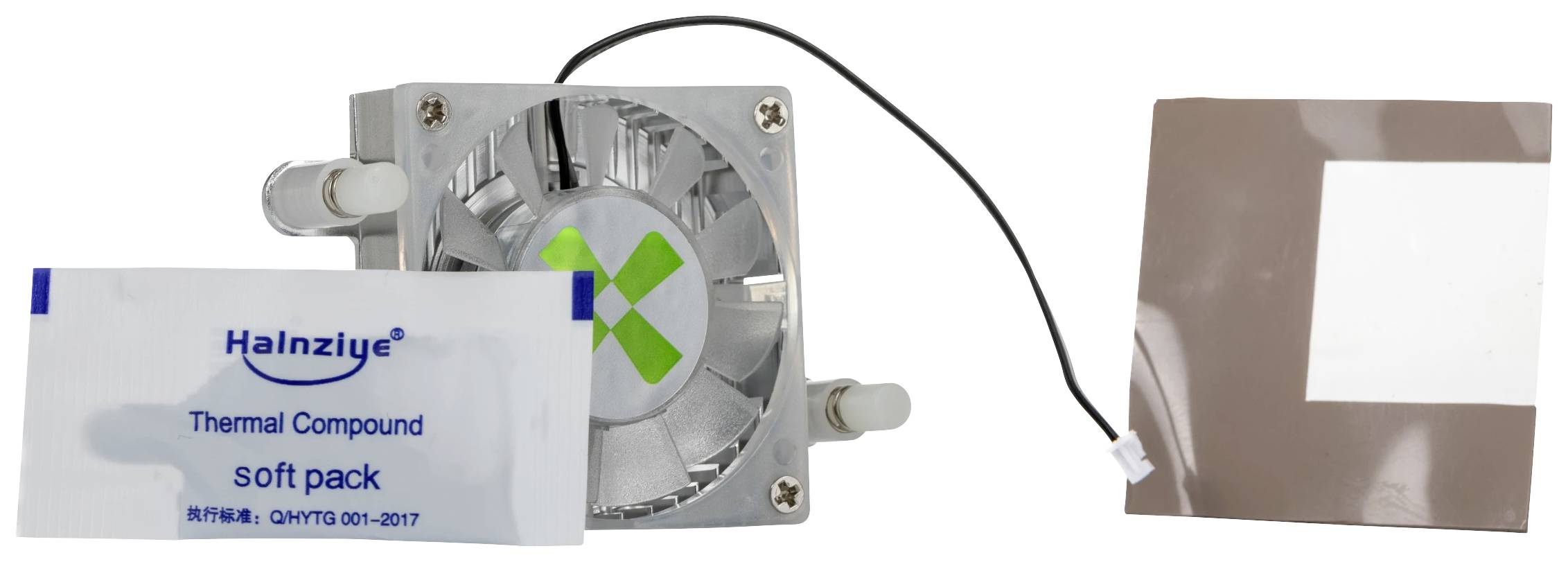 Fan and thermal paste with packaging. The fan has a cable and a green X in the centre. Accessories for computer cooling.