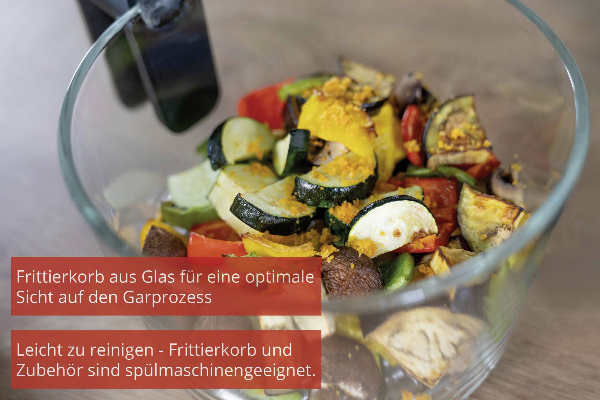 A glass bowl with mixed colourful vegetables. Text: 'Glass frying basket for optimal visibility of the cooking process. Easy to clean - frying basket and accessories are dishwasher-safe.'