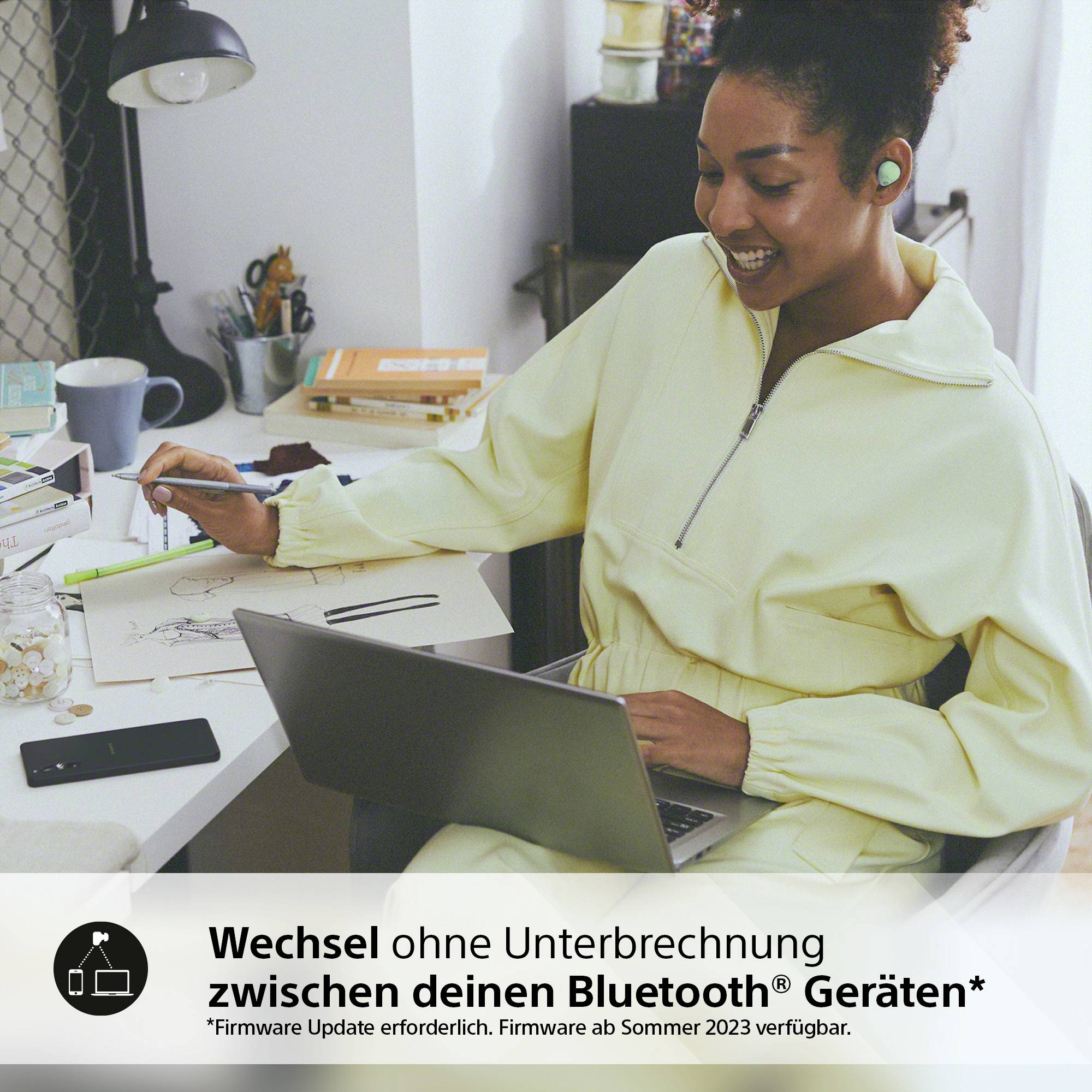 A person is working on a laptop and using wireless earbuds. Text below: Switch seamlessly between your Bluetooth devices.