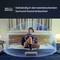 A person is sitting on a bed and using a tablet. Around them is a visualisation of 360-degree spatial sound.
