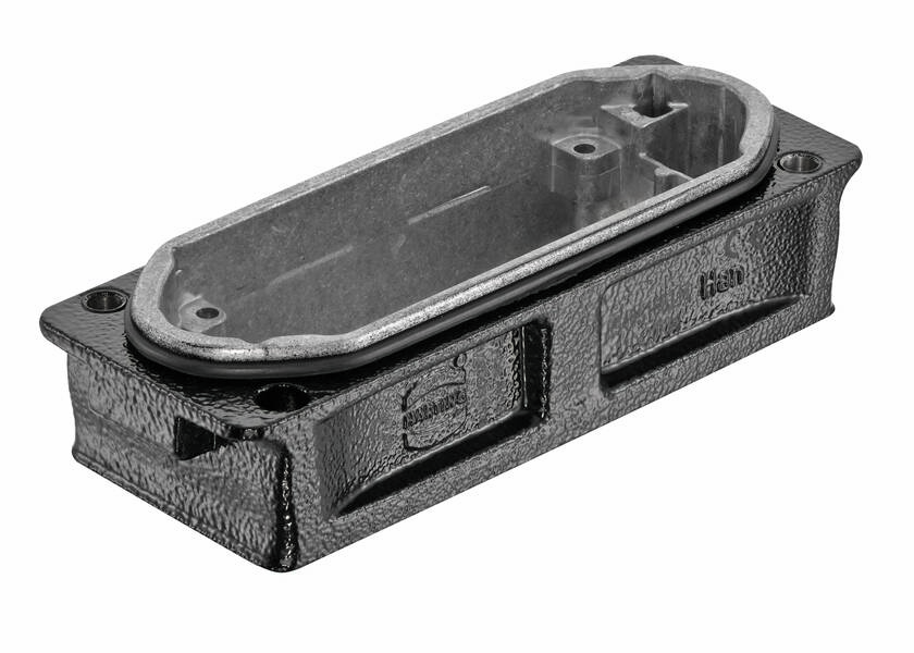 Metal enclosure, rectangular, with rounded corners and two mounting slots. Surface textured, with no visible screws.