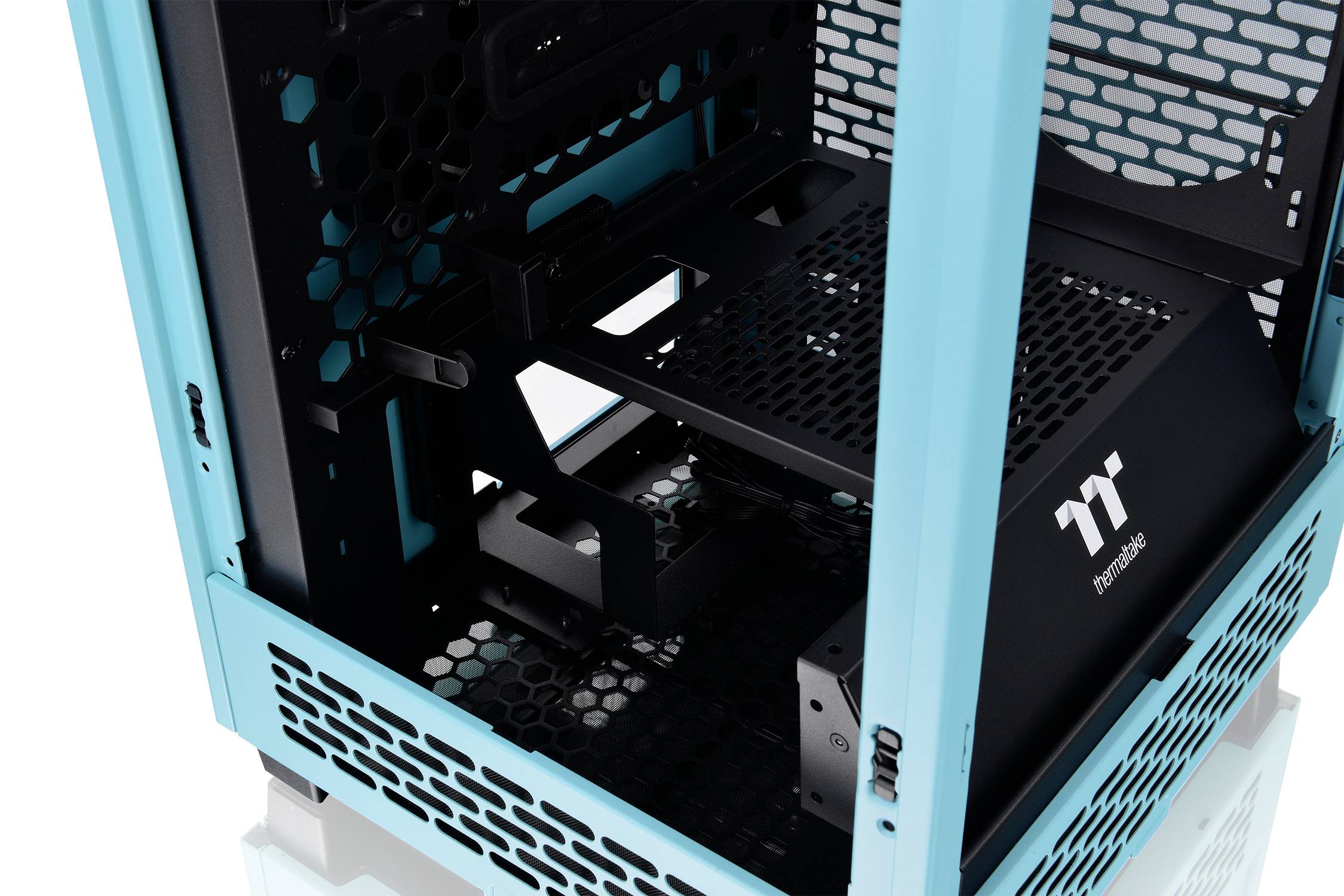 A blank, turquoise PC case with a black inner frame and perforated ventilation openings is shown.