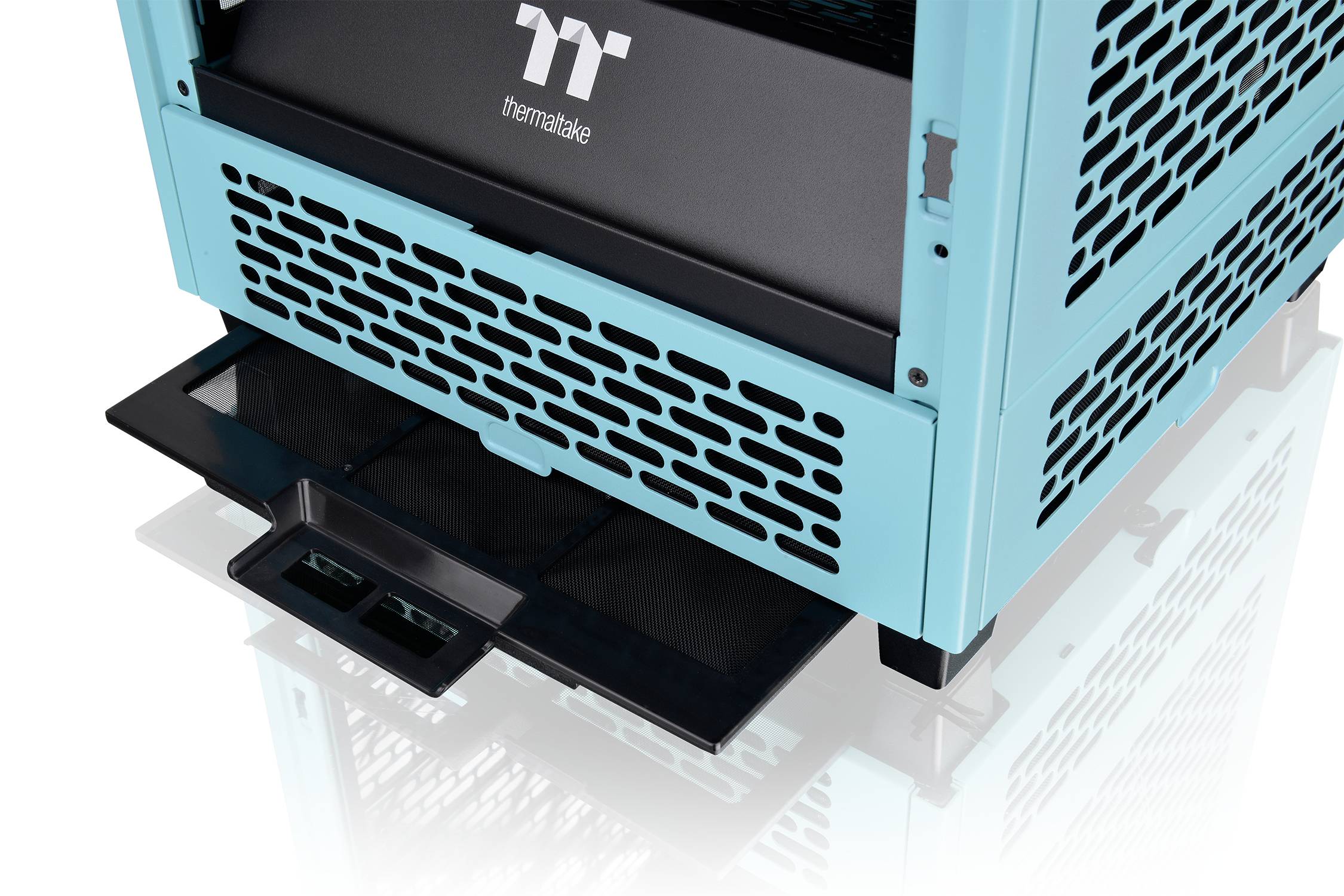 A turquoise computer case with an extendable drawer and ventilation grilles, brand 'Thermaltake'.