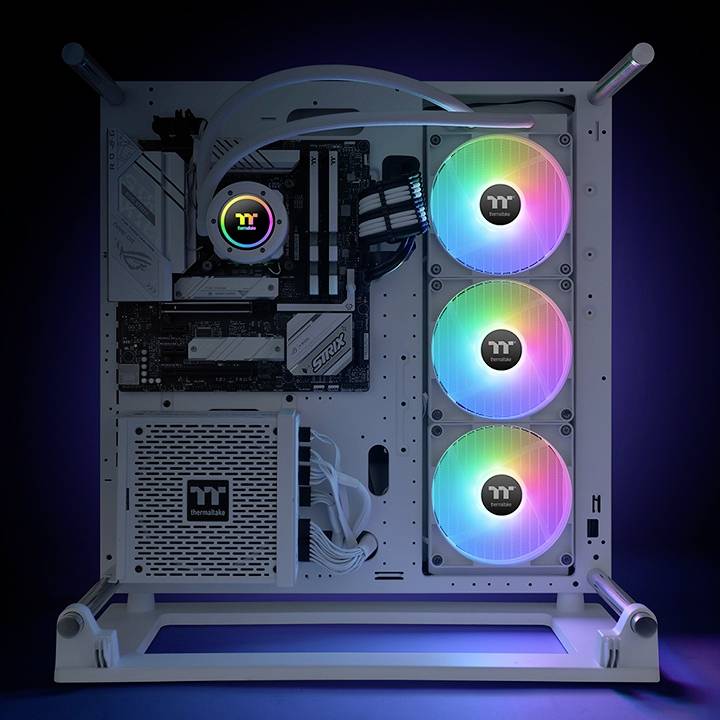Computer case with visible hardware and RGB-illuminated fans glowing in rainbow colours, set against a dark background.