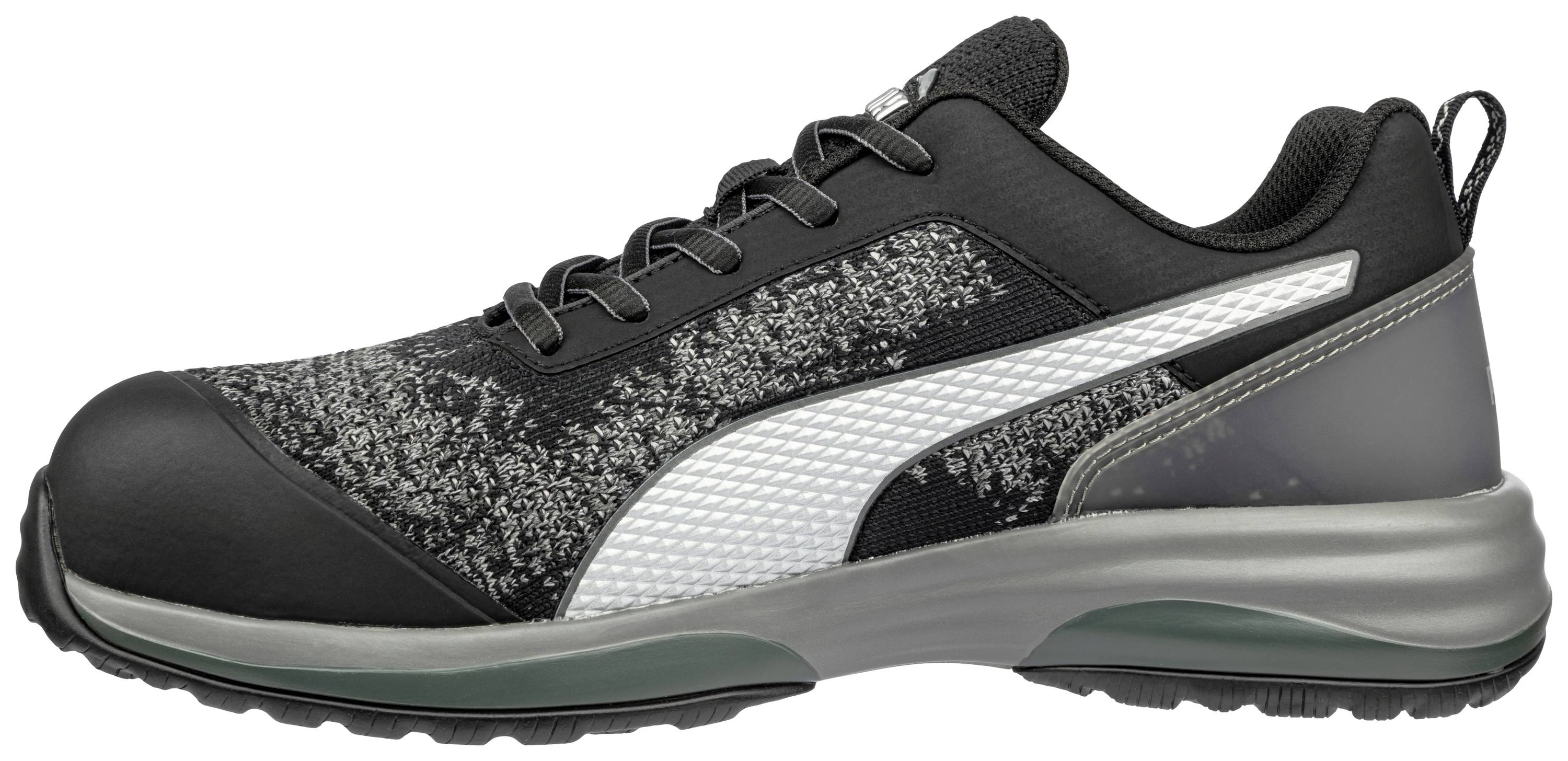 Black trainer with grey pattern, white stripe on the side, grey sole, and black lacing system.