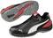 'Black safety shoes with red and white detailing, non-slip grey sole, suitable for use in industrial environments.'