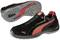 Black sports shoe with red Puma logo and red accents, side view with sole profile visible.