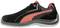 Black sports shoe with red accents and white decorative stitching, side view.