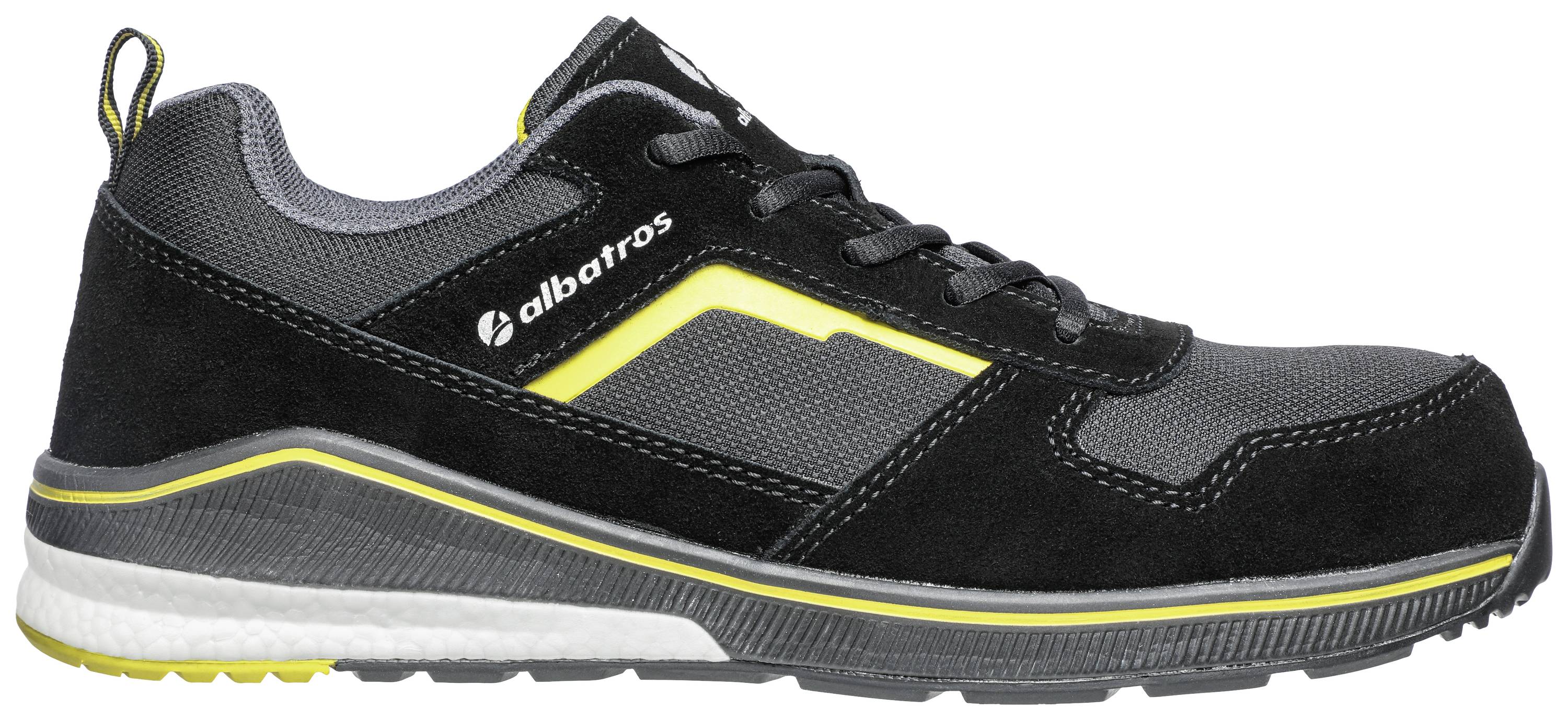 Black and grey sports trainer with yellow accents, side view. The trainer has a thick, padded sole and laces.